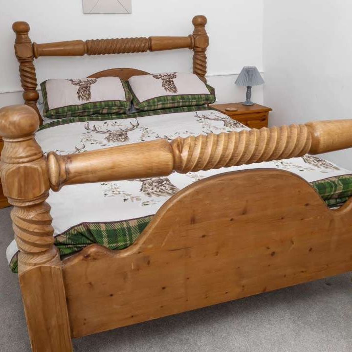 Wooden Double Bed With Stag Bed Spread as part of Accommodation at The Sorrel Horse Inn, Shottisham, Suffolk.
